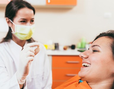Dentist holding tooth after successful extraction