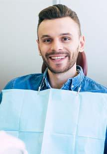 Man smiling while getting a dental checkup in Westfield