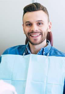 Man smiling while getting a dental checkup