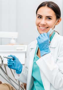 Dentist smiling at patient's dental exam