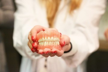 Dentist holding dentures